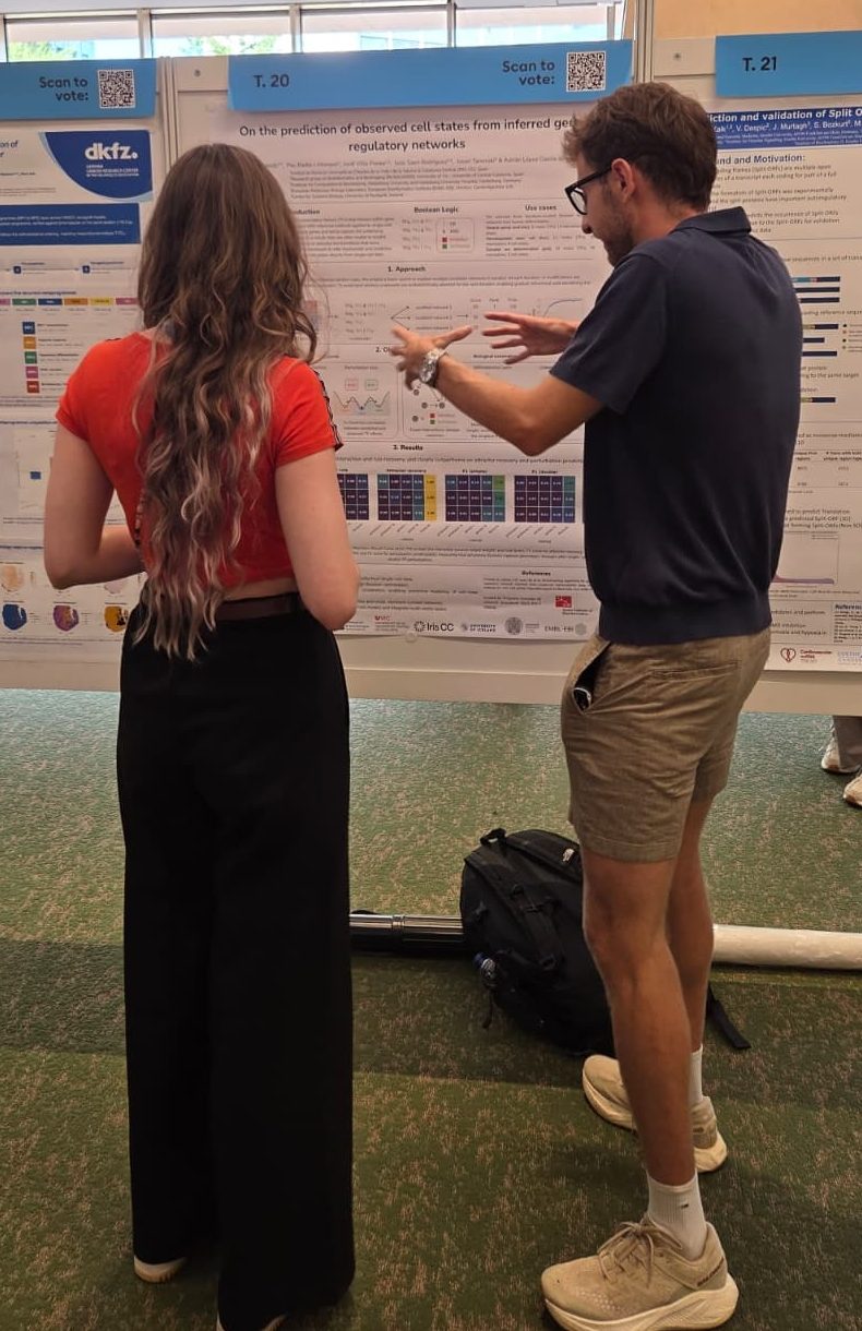 Roger Casals discussing his poster with a colleague during the ECCB 2026 poster session
