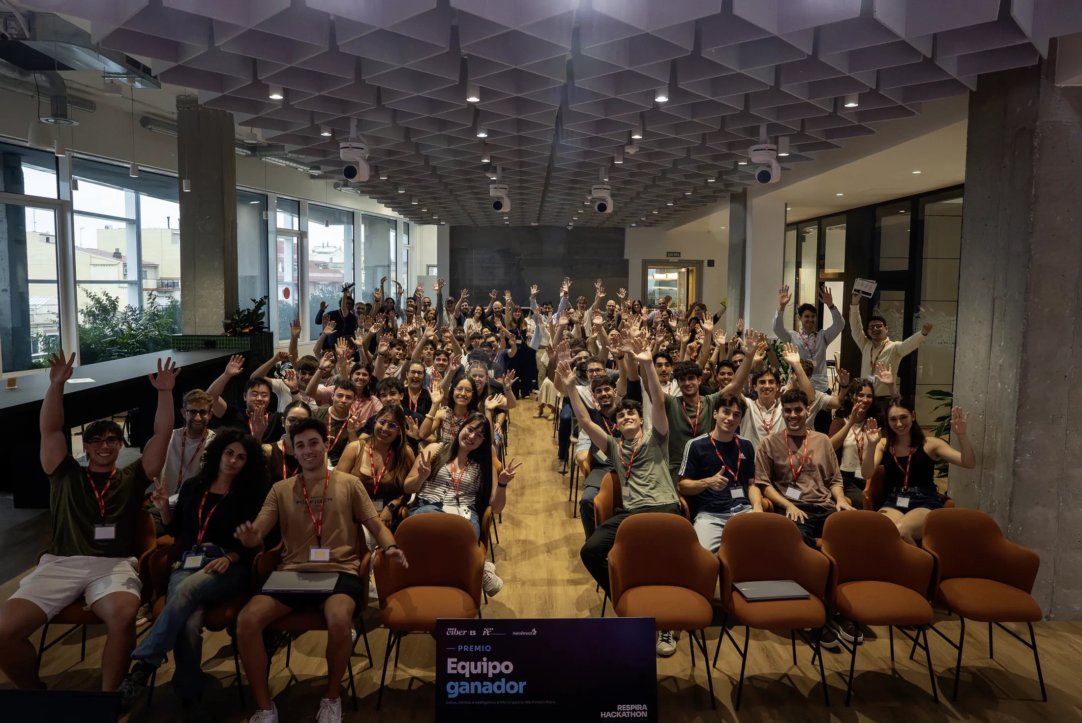 Group photo of all Respira Hackathon participants raising their hands