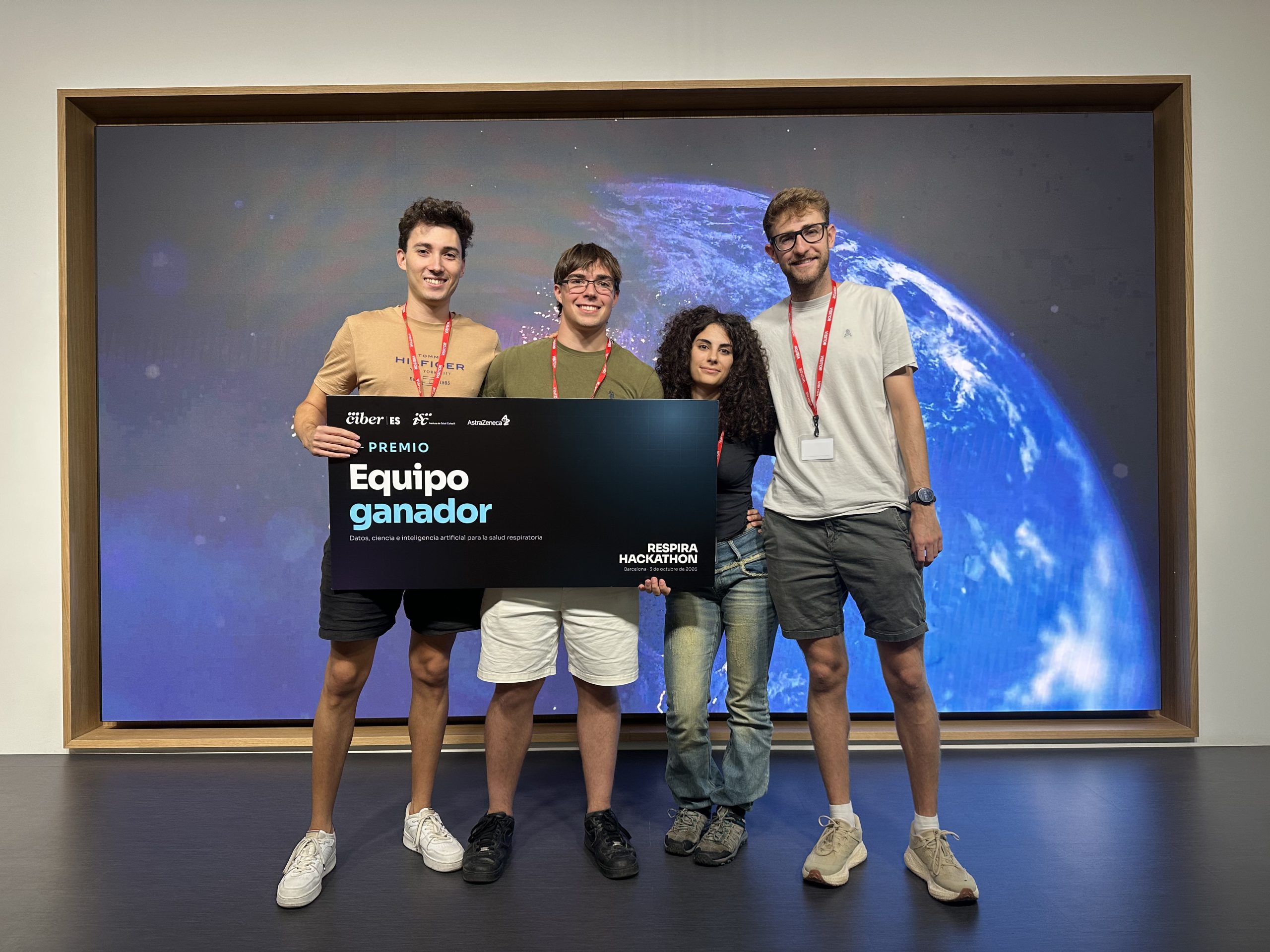 The four team members holding the Respira Hackathon winning team sign